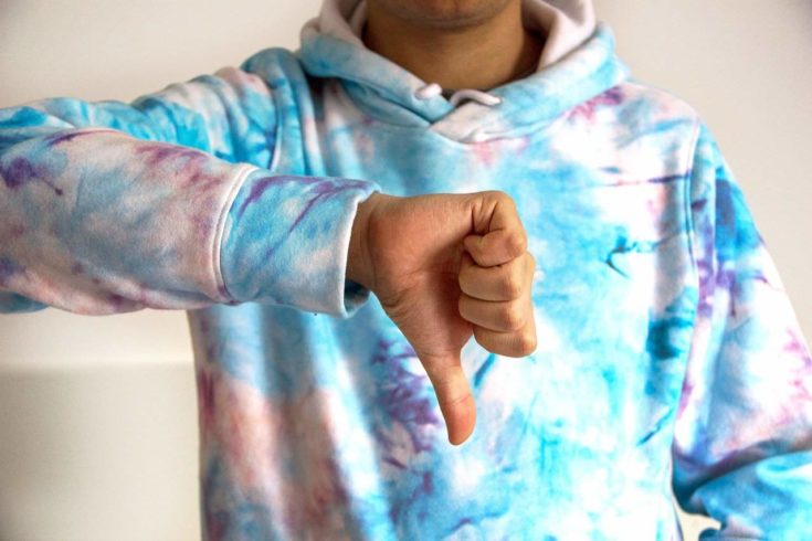 Crop image of man with thumbs down