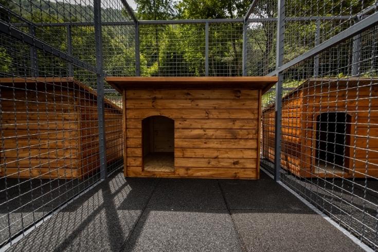 Wooden dog houses in cage