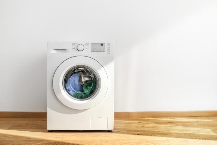 Working washing machine on white background